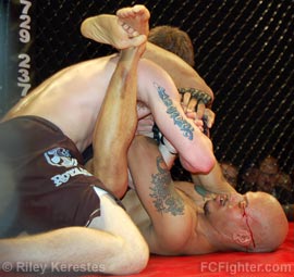 Cage Fighting Championships Underground: Ryan Bixler fending off one of Steve Kinnison's many armbar attempts - Photo by Riley Kerestes