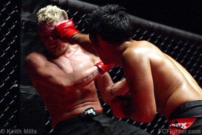 Malice at the Palice (Sep. 9, 2006): Nam Phan punching Aric Nelson - Photo by Keith Mills