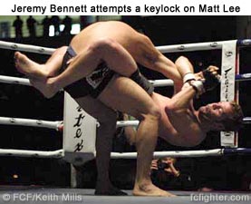 Jeremy Bennett attempts keylock on Matt Lee