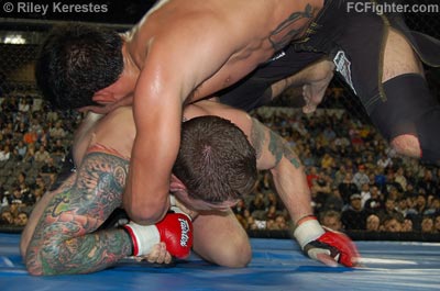 XFO 13: Rafael Assuncao hammers Jeff Curran with a knee to the body - Photo by Riley Kerestes