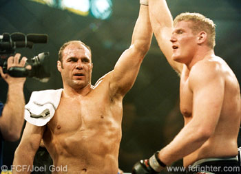 Randy Couture raises Josh Barnett's hand in victory after their fight at UFC 36