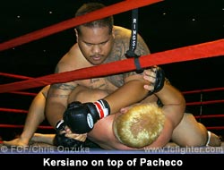 Moses Kersiano drives a forearm into Dustin Pacheco's neck
